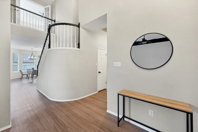 a view of a livingroom with wooden floor and a staircase
