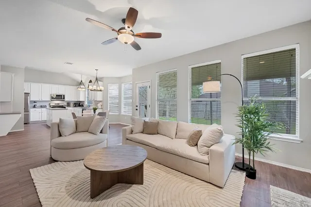 a living room with furniture and a large window