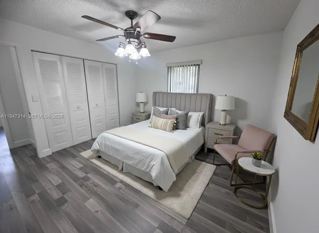 a spacious bedroom with a bed and a chandelier