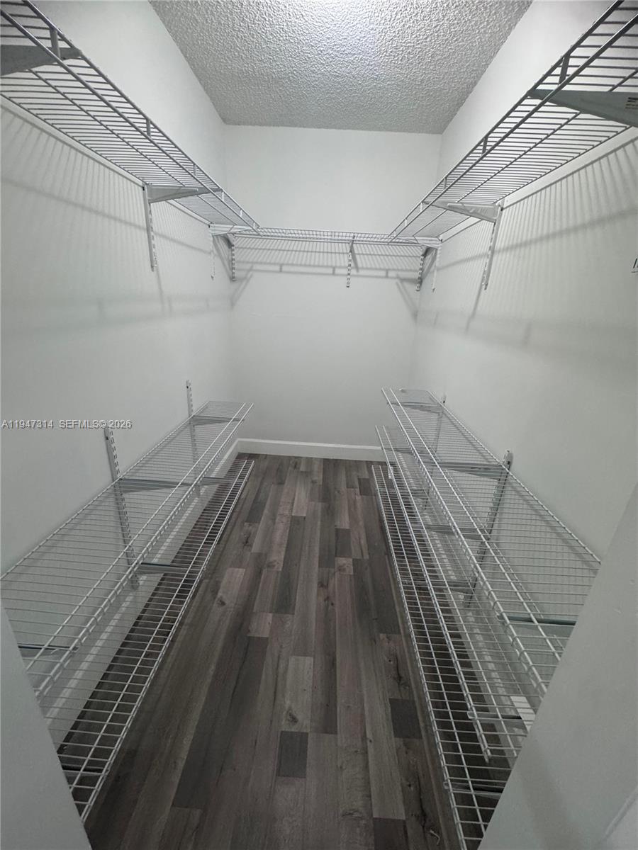 6875 Southwest 148th Court Miami, FL 33193 - Photo 10 of 16 a view of a room with racks on the wall