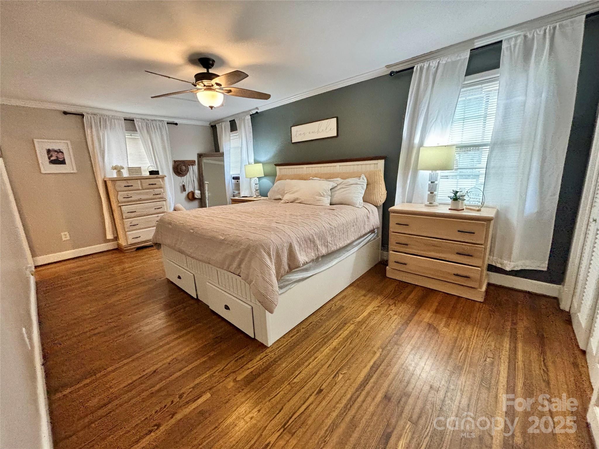 707 West Barr Street Lancaster, SC 29720 - Photo 11 of 43 a spacious bedroom with a bed and a chandelier