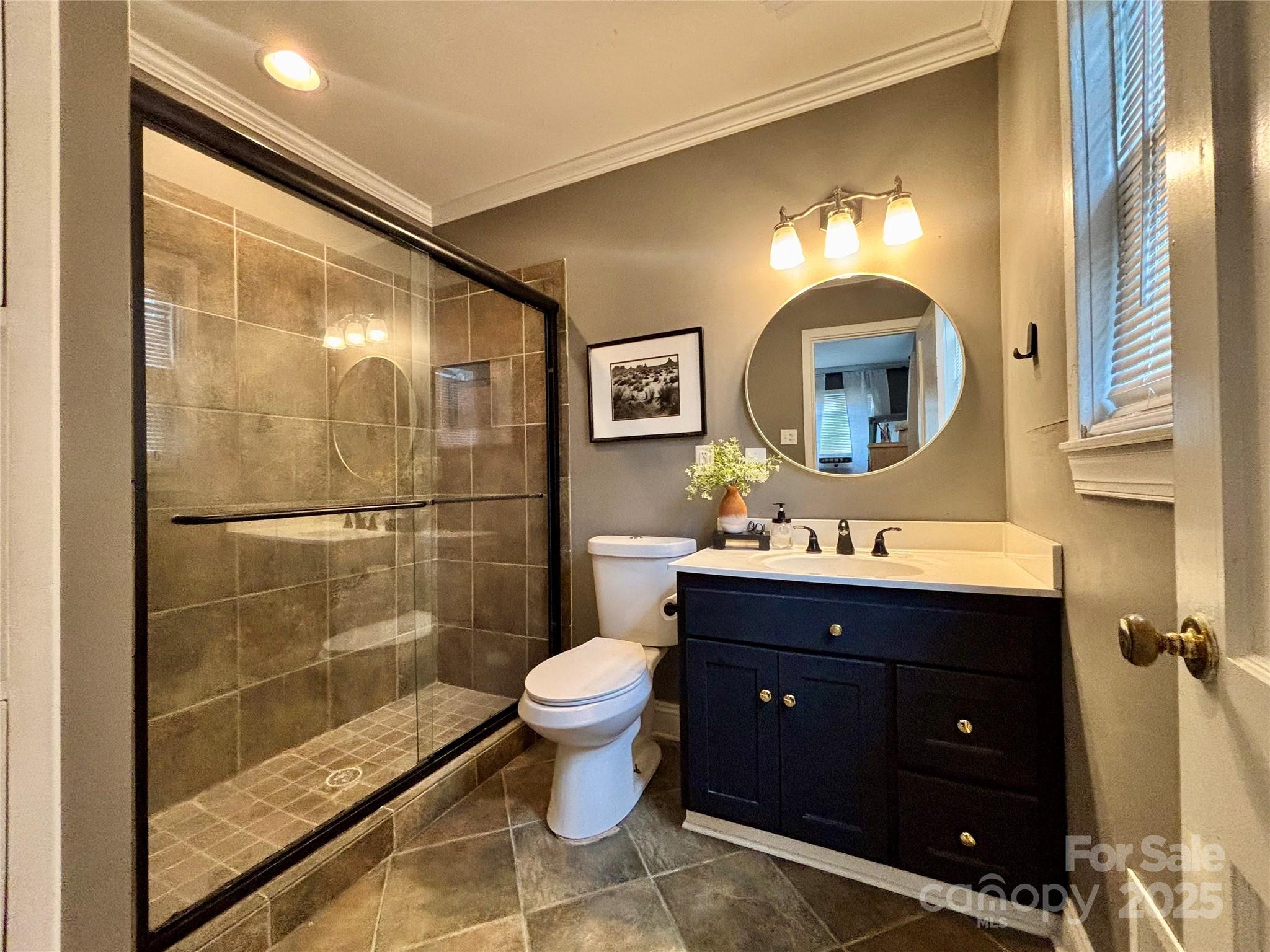 707 West Barr Street Lancaster, SC 29720 - Photo 14 of 43 a bathroom with a toilet a sink and mirror