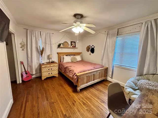 a bedroom with a bed couch and a window