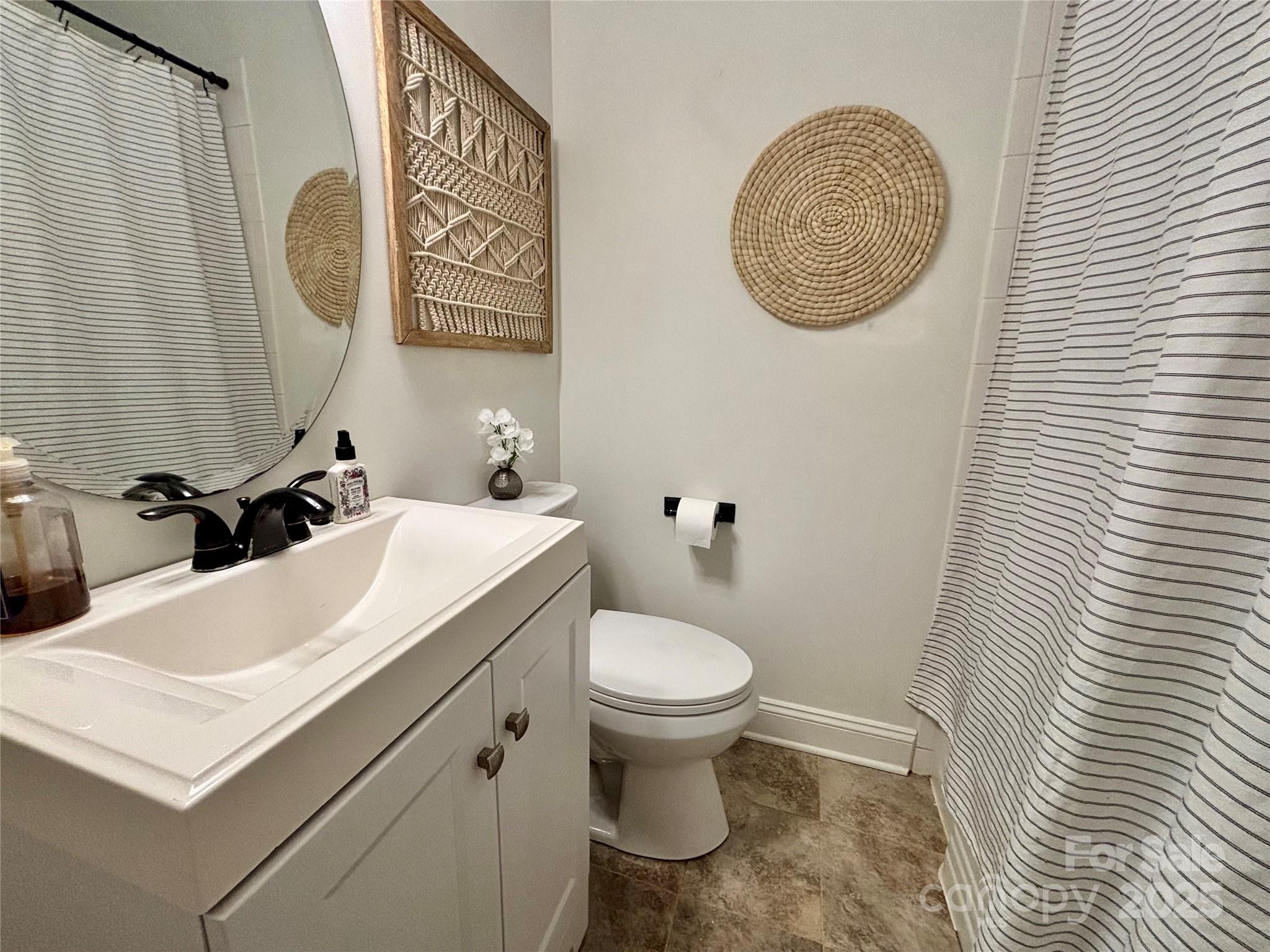 707 West Barr Street Lancaster, SC 29720 - Photo 17 of 43 a bathroom with a toilet sink and mirror