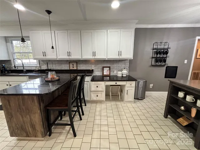 a kitchen with stainless steel appliances granite countertop a stove a sink dishwasher and cabinets with wooden floor