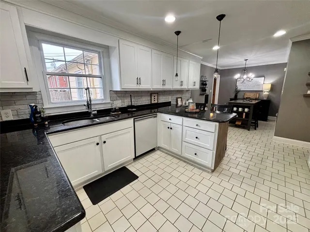 a kitchen with stainless steel appliances a sink stove and cabinets