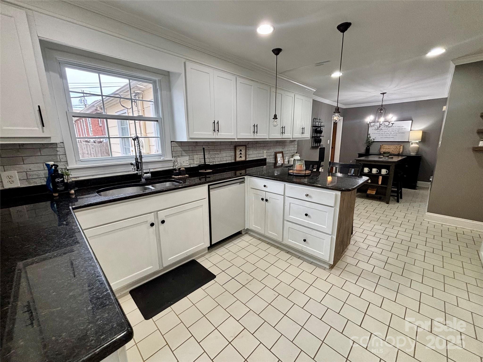 707 West Barr Street Lancaster, SC 29720 - Photo 22 of 43 a kitchen with stainless steel appliances a sink stove and cabinets