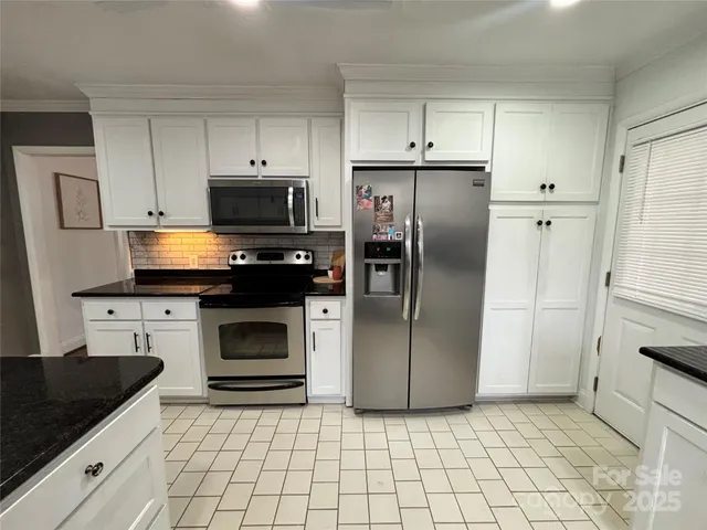a kitchen with a refrigerator stove and microwave