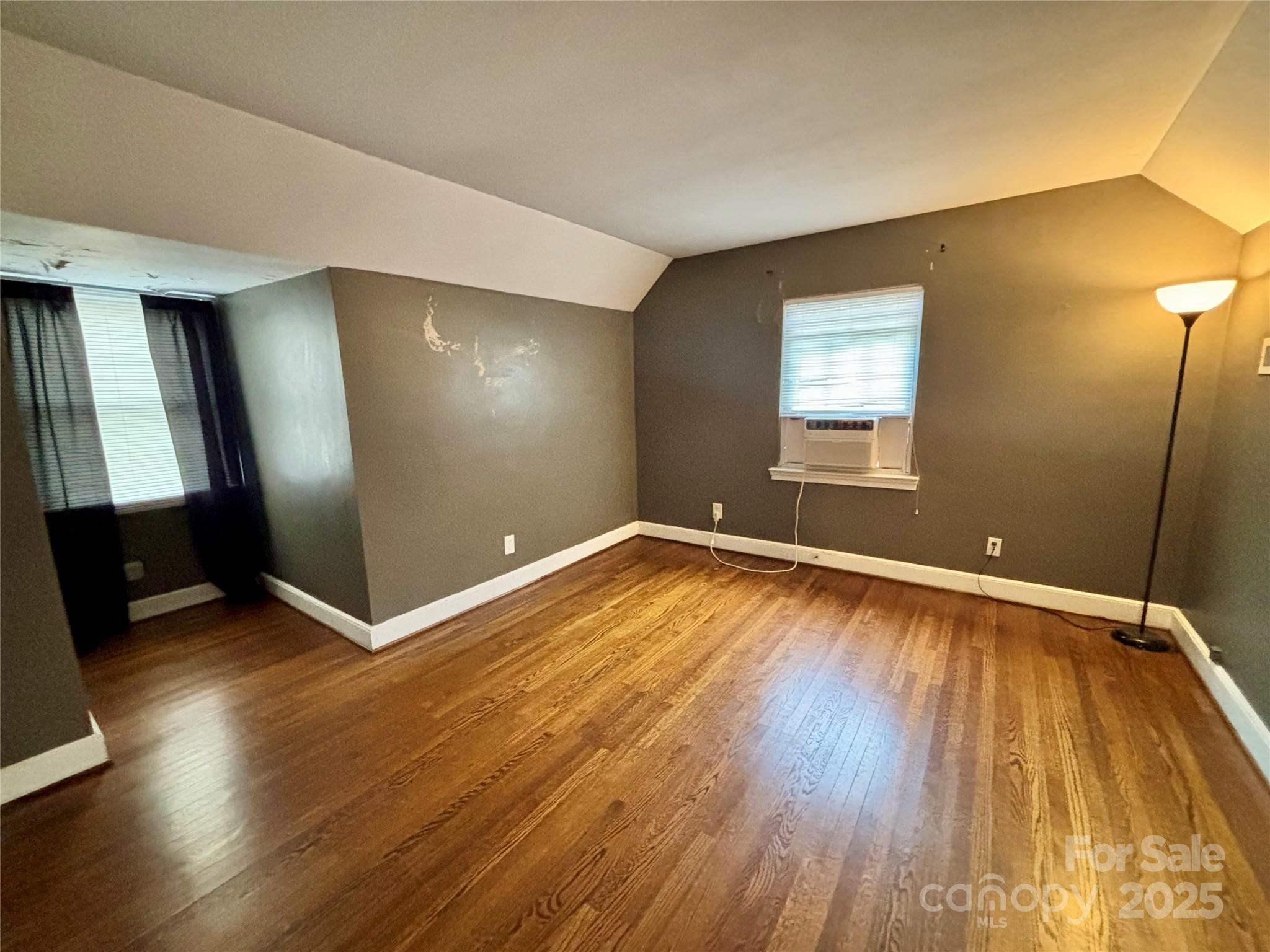 707 West Barr Street Lancaster, SC 29720 - Photo 35 of 43 an empty room with wooden floor and windows