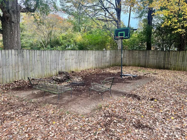 a view of a chairs and yard in the back yard