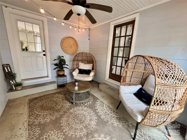 a living room with furniture a window and a chandelier