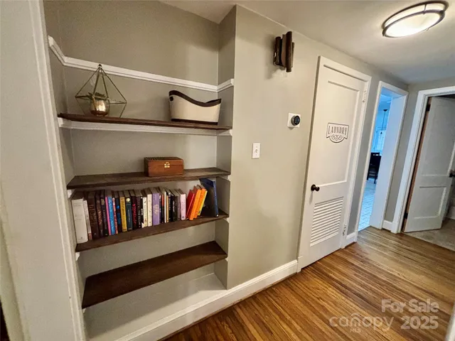 a view of bedroom with furniture and wooden floor