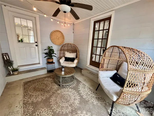 a living room with furniture a window and a chandelier