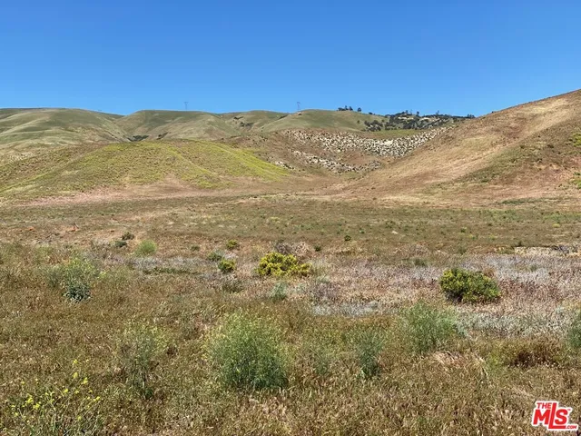 a view of a mountain range in a cloudy sky