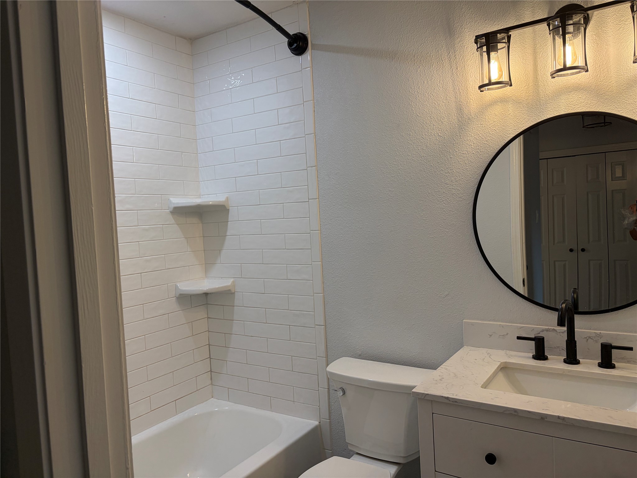 3109 Plantation Road, Unit B Austin, TX 78745 - Photo 2 of 8 a bathroom with a sink a toilet and a mirror