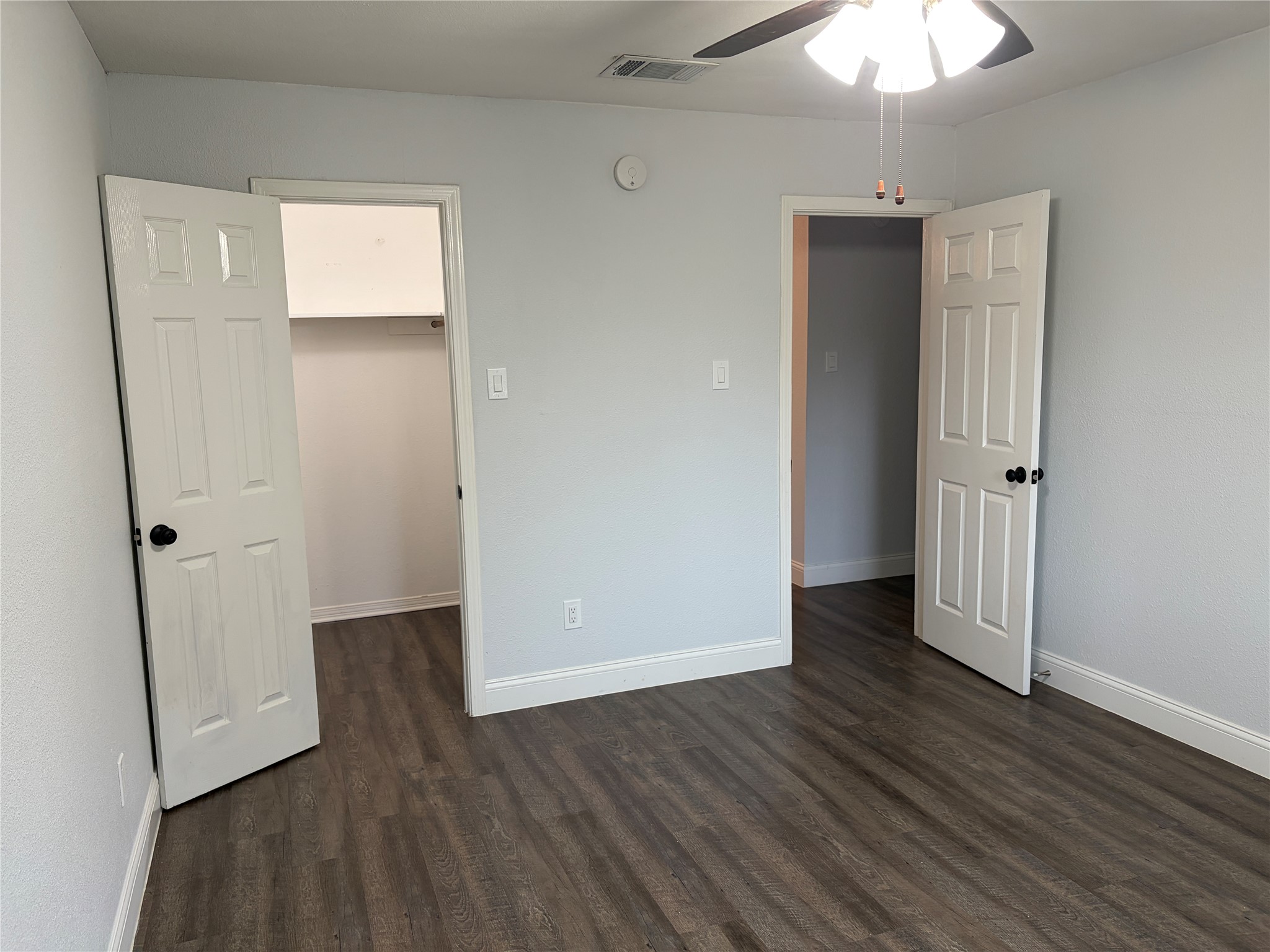 3109 Plantation Road, Unit B Austin, TX 78745 - Photo 5 of 8 an empty room with wooden floor and ceiling fan