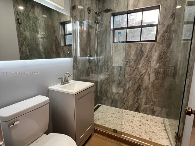 a bathroom with a sink toilet and shower
