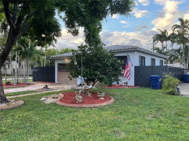 a house that has a big yard and large trees