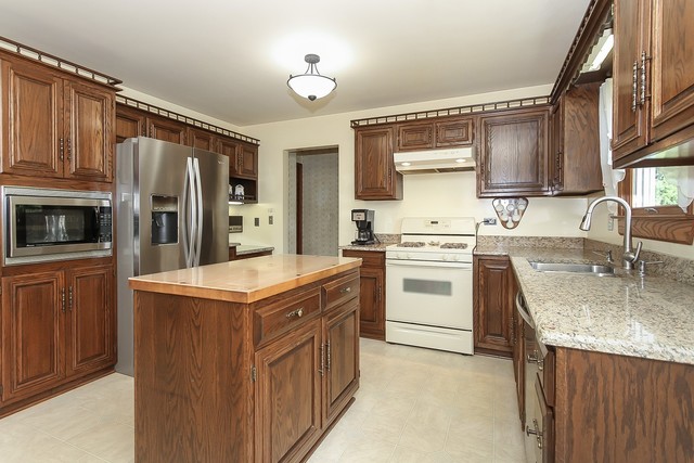 42W930 McDonald Road Elgin, IL 60124 - Photo 4 of 20 a kitchen with stainless steel appliances granite countertop a sink stove and refrigerator