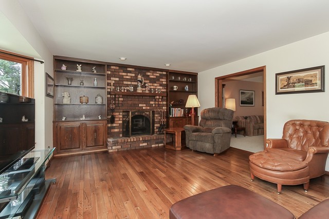 42W930 McDonald Road Elgin, IL 60124 - Photo 9 of 20 a living room with furniture and a fireplace