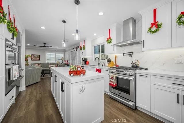a kitchen that has a lot of white cabinets and white appliances