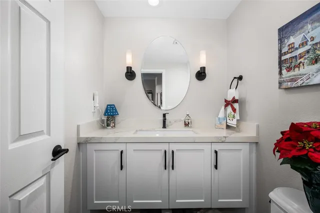a spacious bedroom with a bed and a chandelier