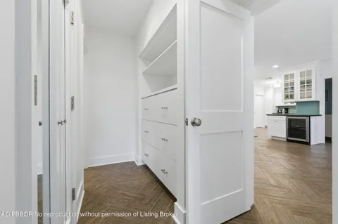 a view of a hallway with kitchen space