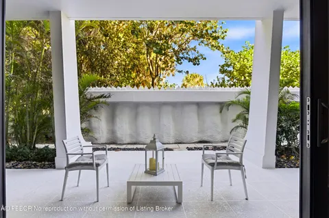 a couple of chairs sitting in patio of a house