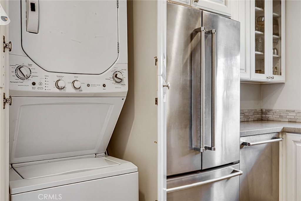 3513 Gondar Avenue Long Beach, CA 90808 - Photo 15 of 30 a view of washer and dryer with kitchen in the background