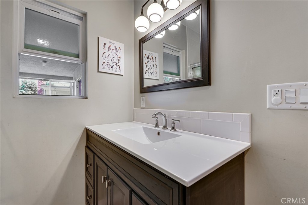 3513 Gondar Avenue Long Beach, CA 90808 - Photo 17 of 30 a bathroom with a sink vanity and a mirror
