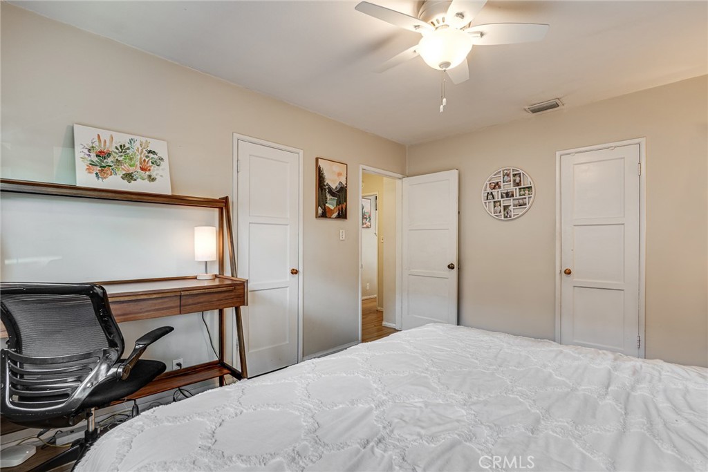 3513 Gondar Avenue Long Beach, CA 90808 - Photo 23 of 30 a bedroom with a bed and a chandelier
