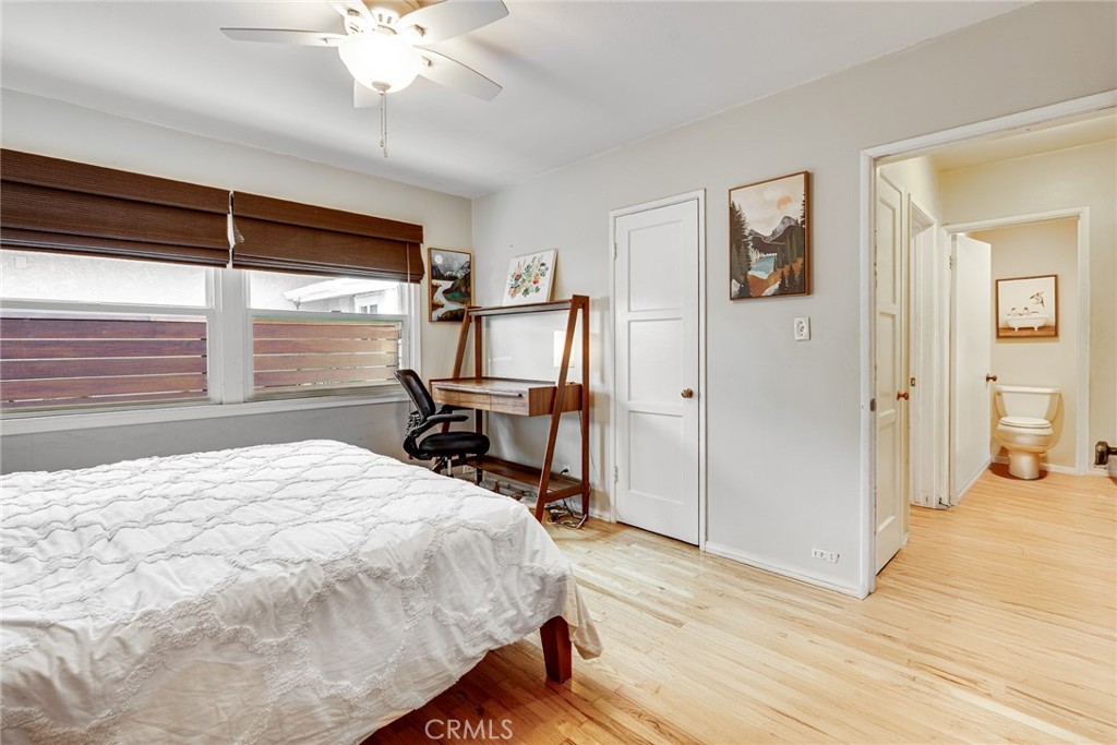 3513 Gondar Avenue Long Beach, CA 90808 - Photo 24 of 30 a bedroom with a bed and a large mirror with wooden floor