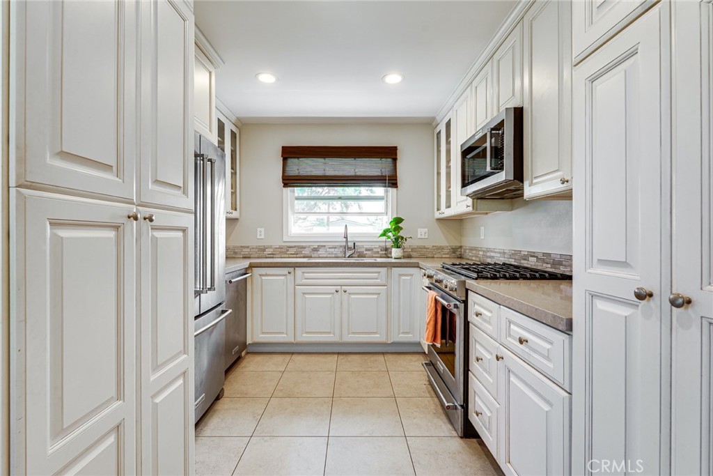 3513 Gondar Avenue Long Beach, CA 90808 - Photo 10 of 30 a kitchen with stainless steel appliances granite countertop a stove and a microwave