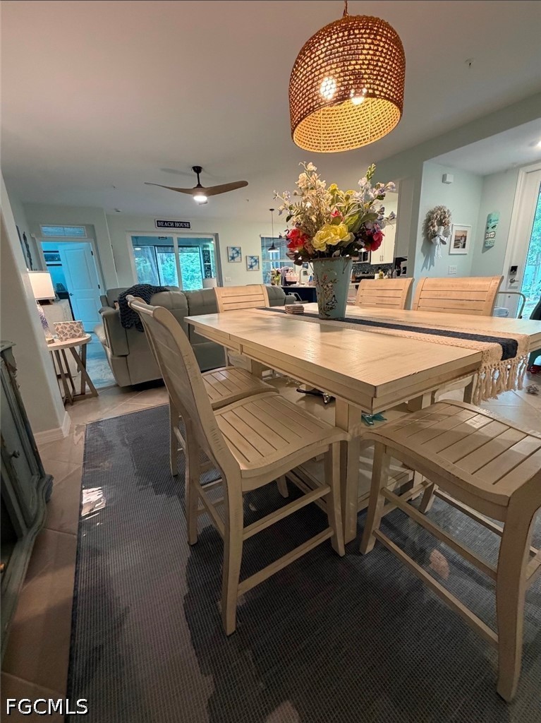 14191 Poppy Fld Loop, Unit 5312 Punta Gorda, FL 33955 - Photo 16 of 41 a room with table chairs and a chandelier