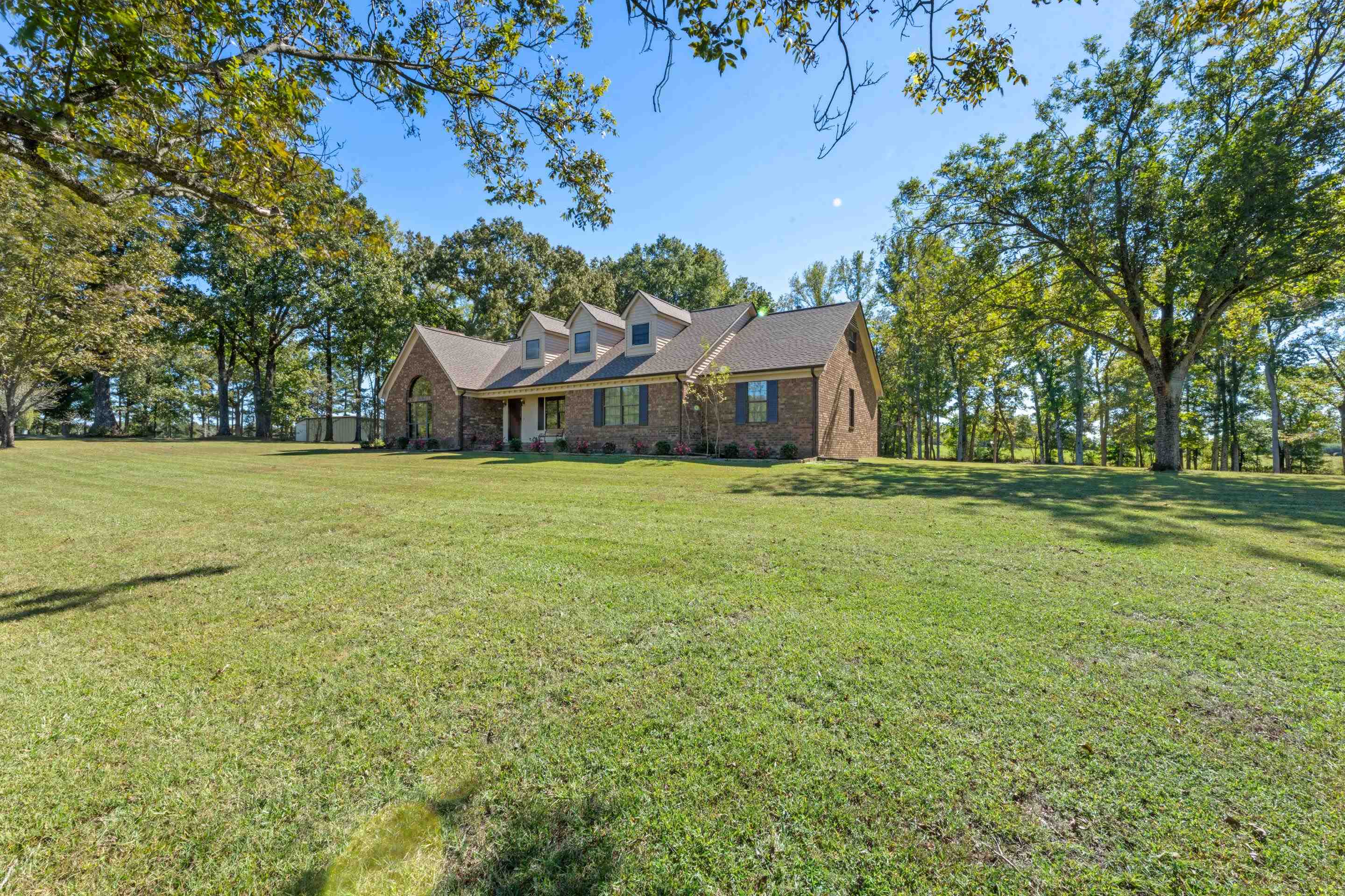 650 Blain Road Rossville, TN 38066 - Photo 30 of 32 Classic brick home nestled on beautifully maintained acreage with mature trees, fresh landscaping, and a peaceful country setting.