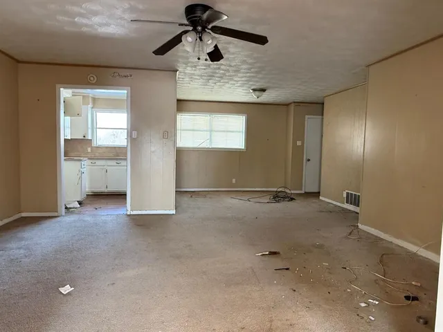 a view of a livingroom with wooden floor and window