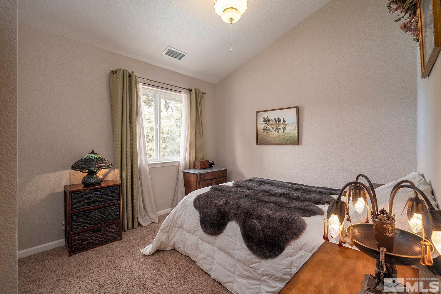 2470 Cartwright Road Reno, NV 89521 - Photo 18 of 29 a bedroom with a bed and a dresser