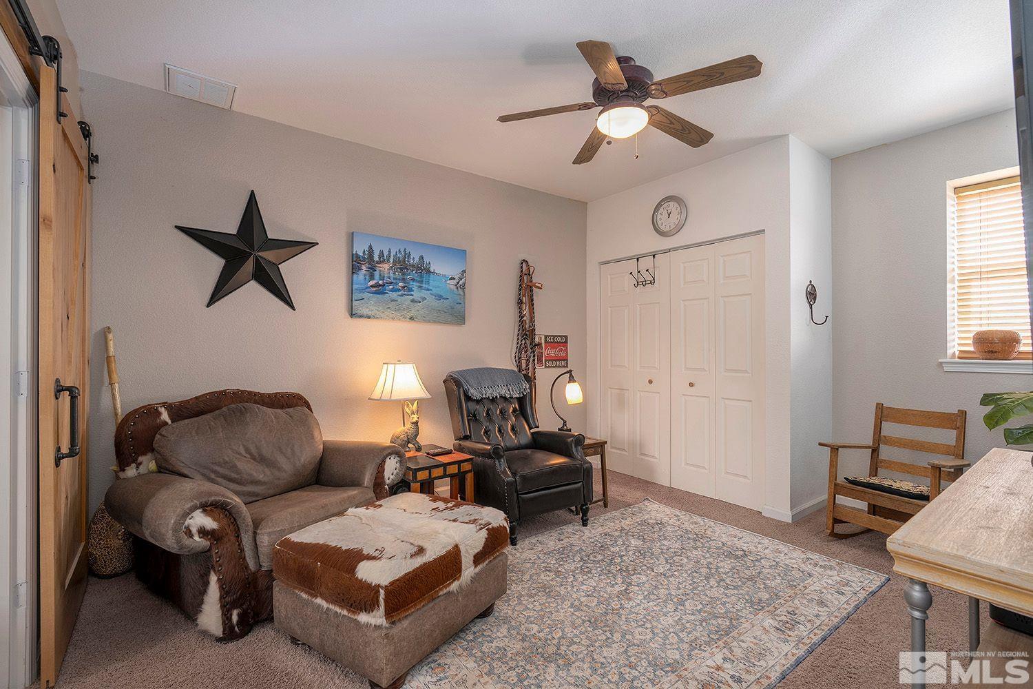2470 Cartwright Road Reno, NV 89521 - Photo 19 of 29 a living room with furniture a ceiling fan and a rug