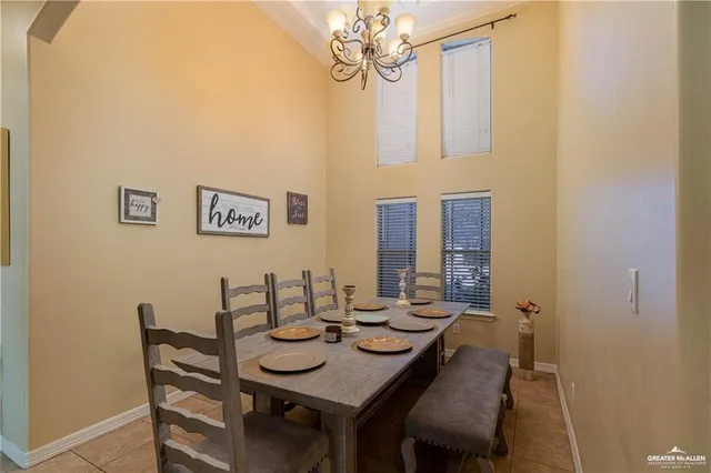 a view of a dining room with furniture and chandelier