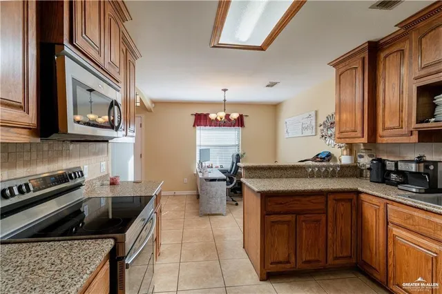 a kitchen with a stove sink and cabinets