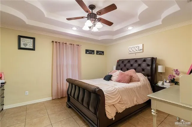 a bedroom with a bed and a ceiling fan