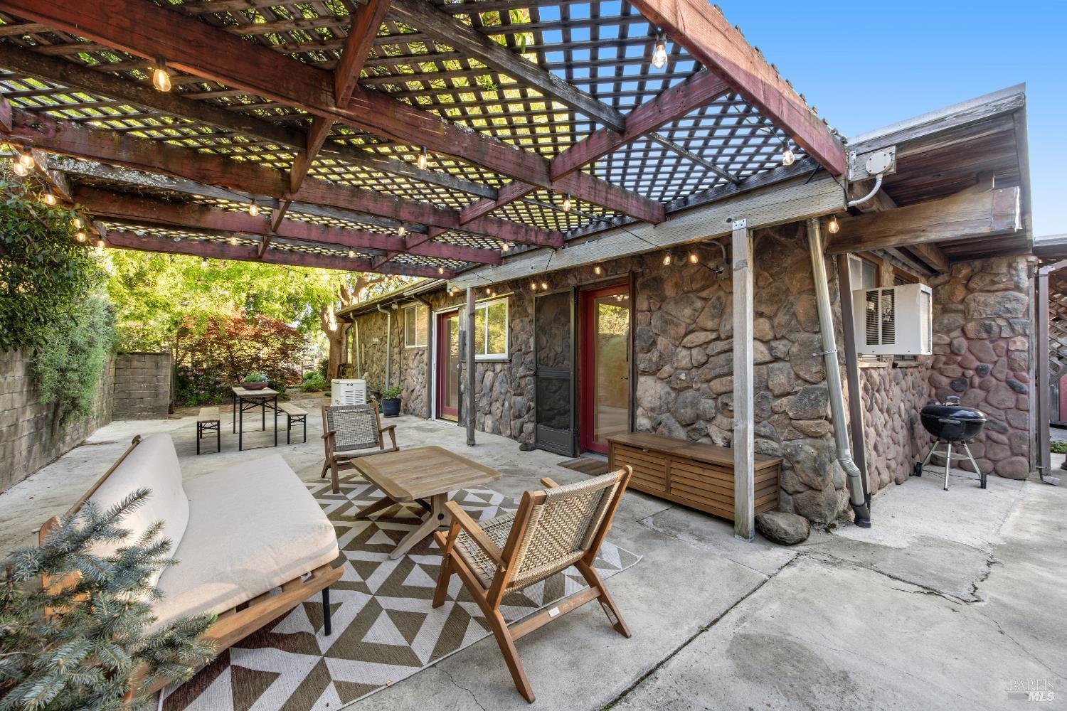 6960 Round Oak Road Penngrove, CA 94951 - Photo 42 of 58 a view of a patio with table and chairs and potted plants