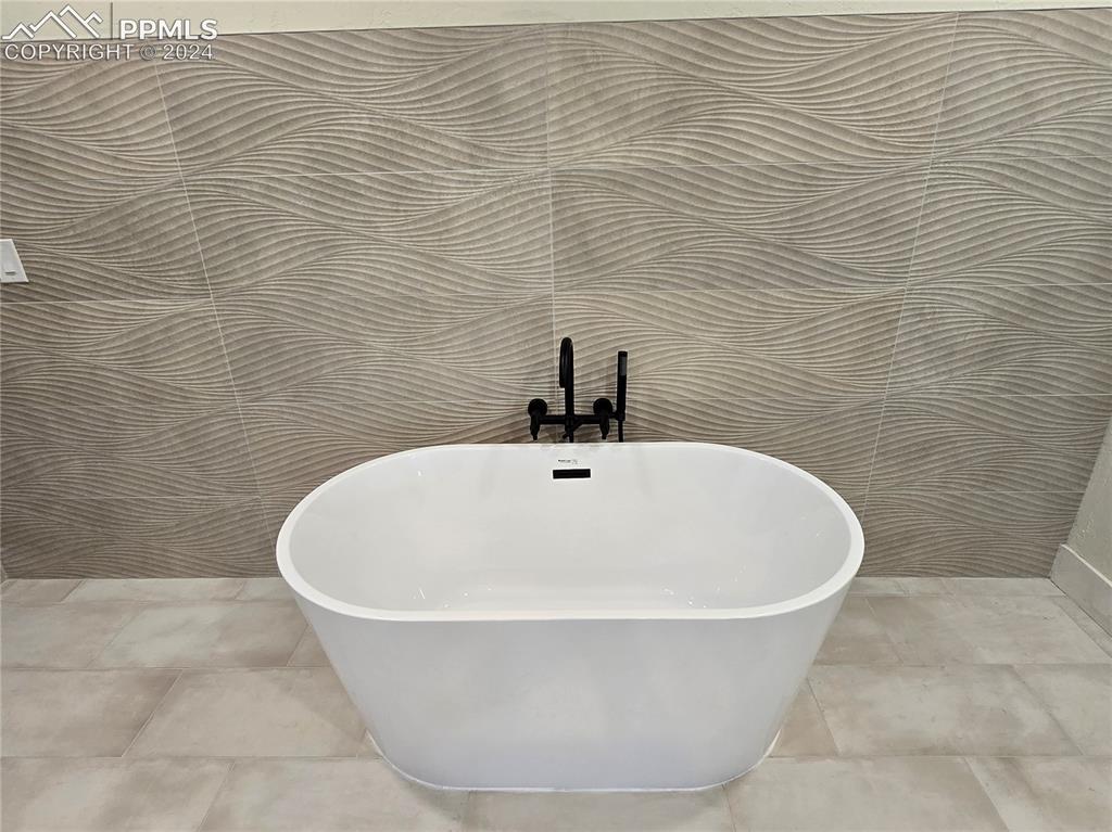 33036 Meadow Ridge Lane Trinidad, CO 81082 - Photo 42 of 50 Details featuring a bathing tub and tile patterned floors