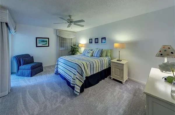 a bedroom with a bed and a couch