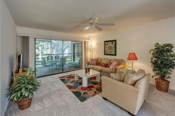 a living room with furniture fireplace and potted plant