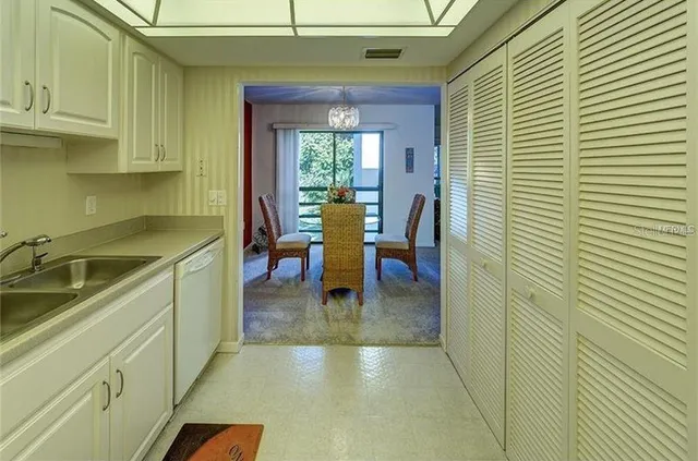 a hallway with a sink and cabinets