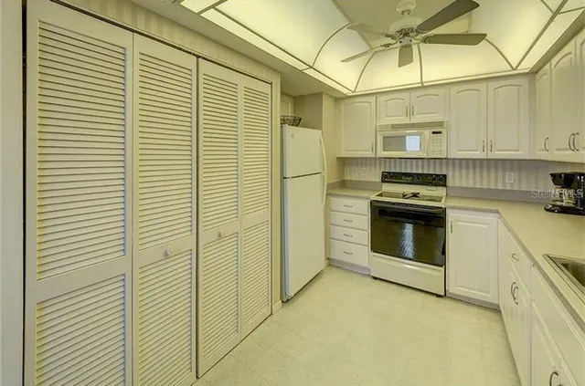 a kitchen with stainless steel appliances cabinets and a window