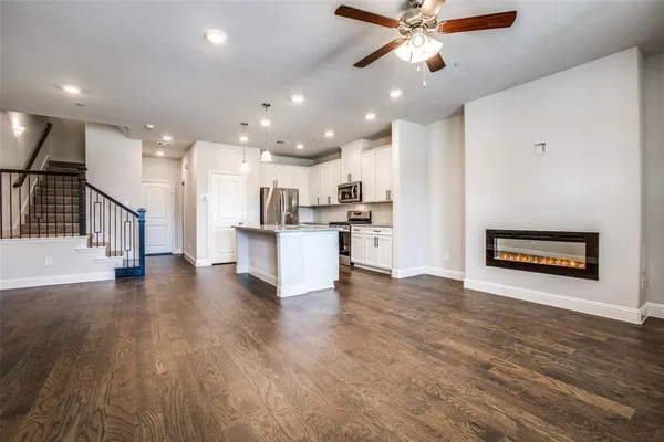 a view of kitchen with sink and refrigerator
