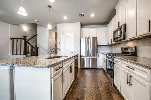 a view of kitchen with sink and wooden floor