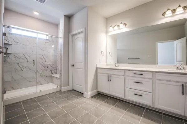 an empty room with windows and a ceiling fan